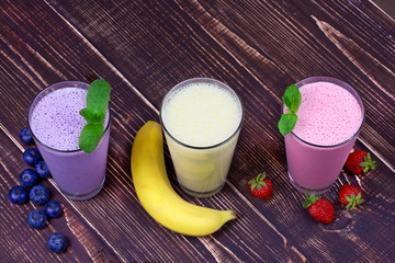 Strawberry, banana and blueberries milkshakes