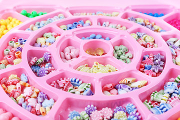 Multicoloured beading kit for children in a pink box