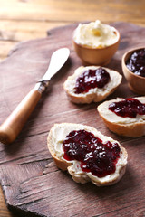 Fresh bread with homemade butter and blackcurrant jam