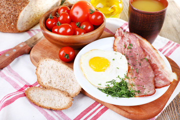 Scrambled eggs with bacon and vegetables served