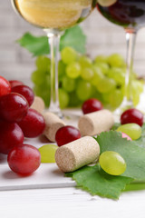 Wine bottle corks with grapes on table close-up