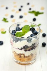 Natural yogurt with fresh berries on wooden table