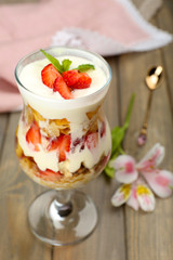 Natural yogurt with fresh berries on wooden table