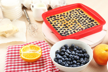 Baking tasty pie and ingredients for it on table in kitchen