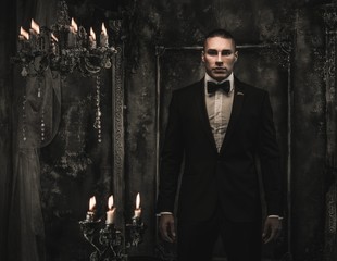Young man wearing tuxedo in classical interior