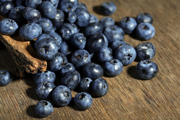 Tasty ripe blueberries, on wooden background