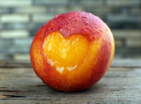 Peach With Heart On Wooden Table, Close-up