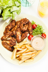 Chicken wings with fries french and spicy sauce