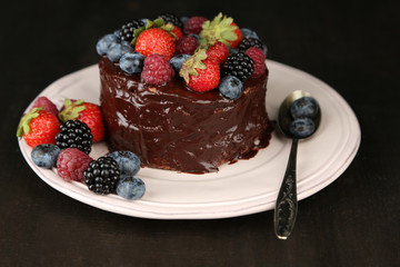 Tasty chocolate cake with different berries