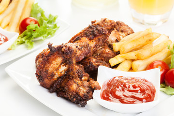 Chicken wings with fries french and spicy sauce