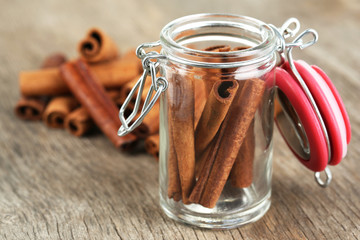 Cinnamon bark in glass bank on wooden table