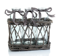 Empty bottles in basket isolated on white