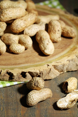 Peanuts in bowl on rustic wooden background