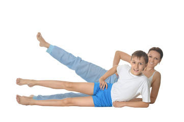 Smilling mother and son exercising