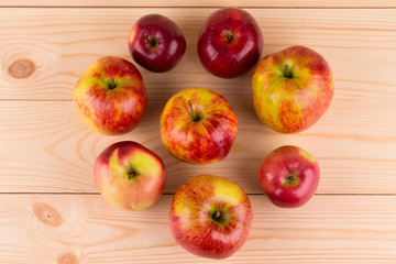 Fresh red apples on wood background.