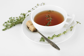 Cup of tasty herbal tea with thyme, isolated on white
