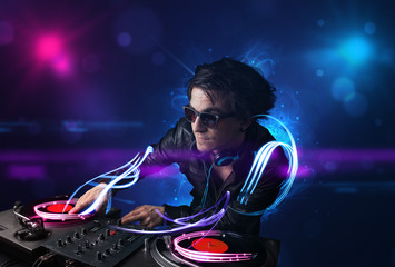 Disc jockey playing music with electro light effects and lights