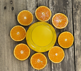 Glass of orange juice and orange slice top view on the table