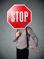 Businessman holding a stop sign