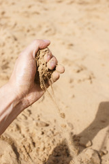 Sand strewing from hand