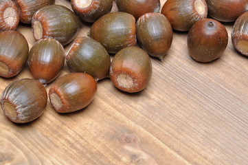 Brown acorns on board close up 