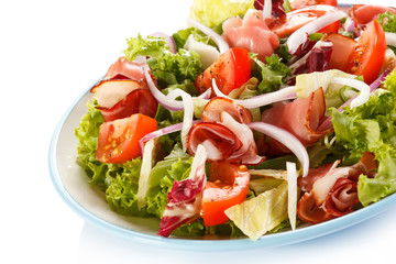 Vegetable salad with ham on white background