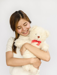 asian teen holding a  bear doll.