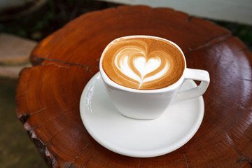 Cup of latte coffee on wooden
