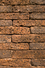 Closeup of vertical red brick wall.