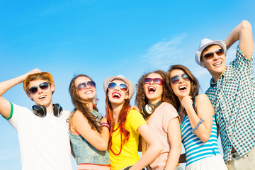 group of young people wearing sunglasses and hat