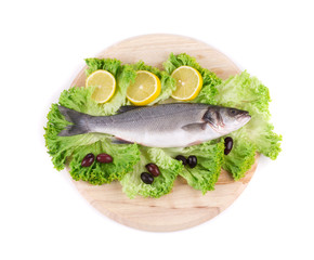 Fresh seabass fish on lettuce.