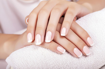 Beautiful woman's nails with french manicure. - obrazy, fototapety, plakaty