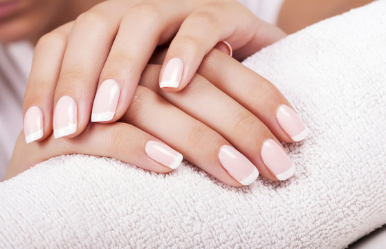 Beautiful woman's nails with french manicure.