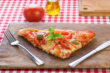 Pizza slice served on rustic wooden board
