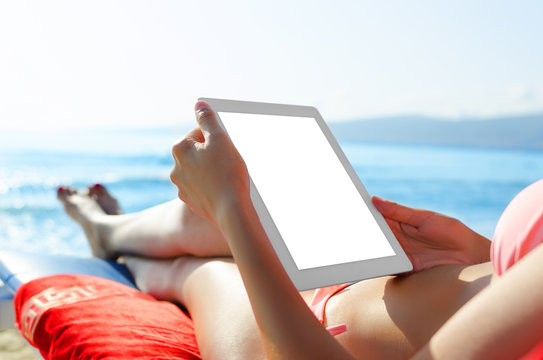 Woman with tablet pc at the beach