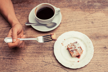 Woman having coffee and cake