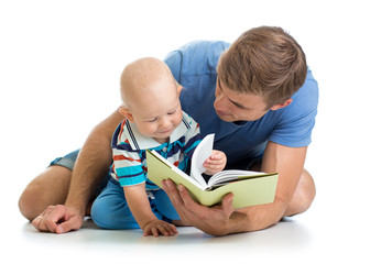 kid boy and his father read a book