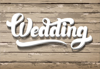 The word Wedding on a wooden background