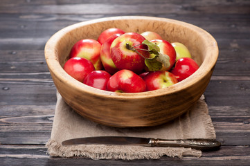 Red apples in rustic bowl