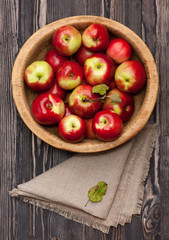 Red apples in rustic wooden bowl