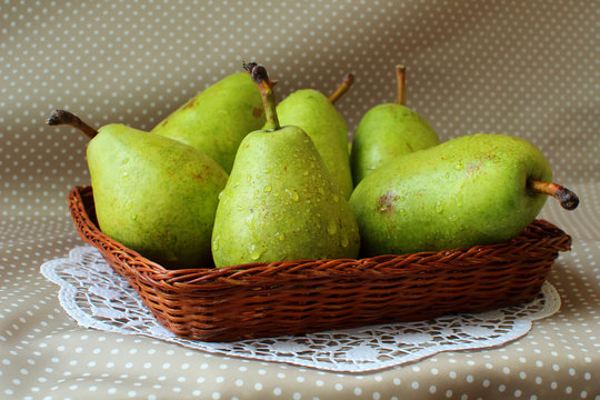 Green pears in a basket.
