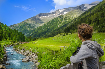 Fototapeta na wymiar Woman looking at the peaks of the Austrian Alps, Zillertal