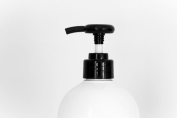 Fototapeta na wymiar close up half of white bottle with black head pump