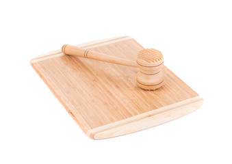 Wooden meat hammer on kitchen board.
