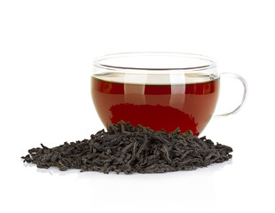 Cup of tea and leaves black tea isolated on white background