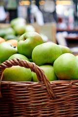 Green apples in basket at the market