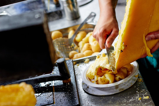 Melted cheese raclette on potatoes