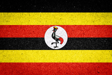 Uganda flag on paper background