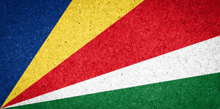 Seychelles flag on paper background © PinkBlue