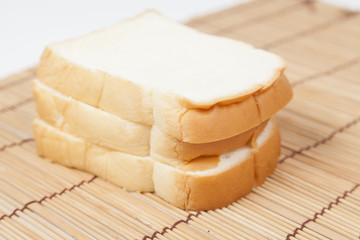 Sliced ​​bread on the wooden plate.